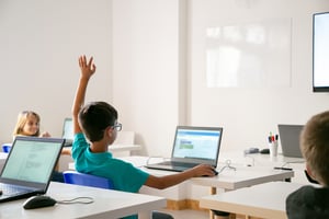 mixed-race-boy-glasses-rising-hand-answer-lesson-1